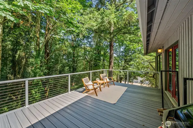 Unwind in style on this sunny lounge deck—accessed through the French doors off the living room—an ideal perch for soaking in the surrounding forest canopy with your favorite book or beverage.