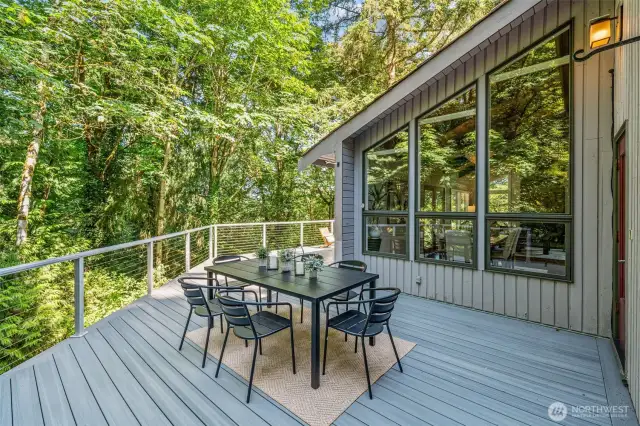 Step out from the kitchen through a separate entrance to this elevated dining deck—ideal for al fresco meals while enjoying the serene treetop views.
