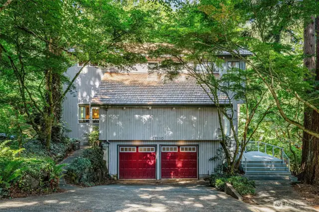 Tucked beneath a canopy of mature trees, this striking Bellevue home makes a bold first impression.