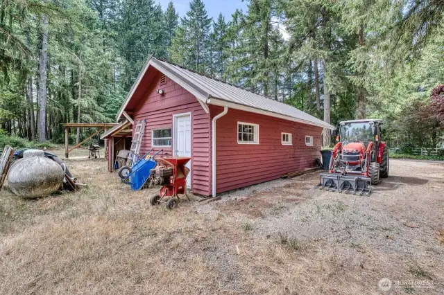 Another view of the detached garage and RV parking spot.