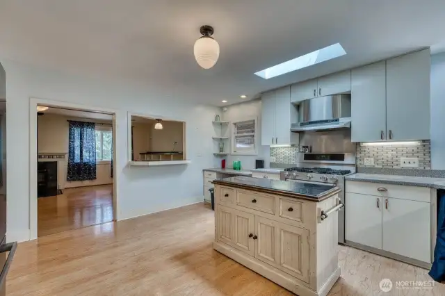 The nice island, under counter lighting and pass through to the living room.
