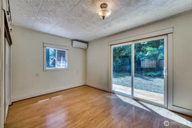 The primary suite with mini split and large slider opens to the spacious deck.