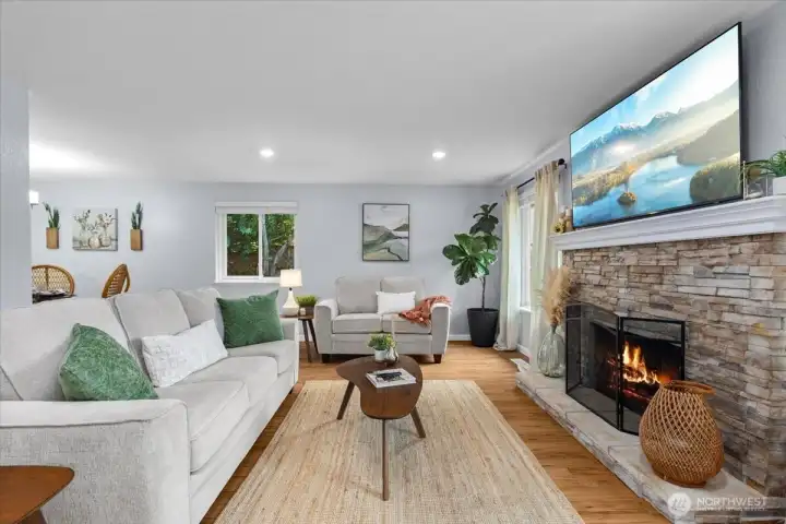 Charming fireplace adds warmth and comfort with stone surround.