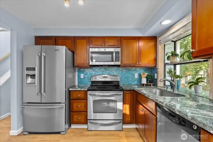 Modern kitchen with granite counters and plenty of storage.