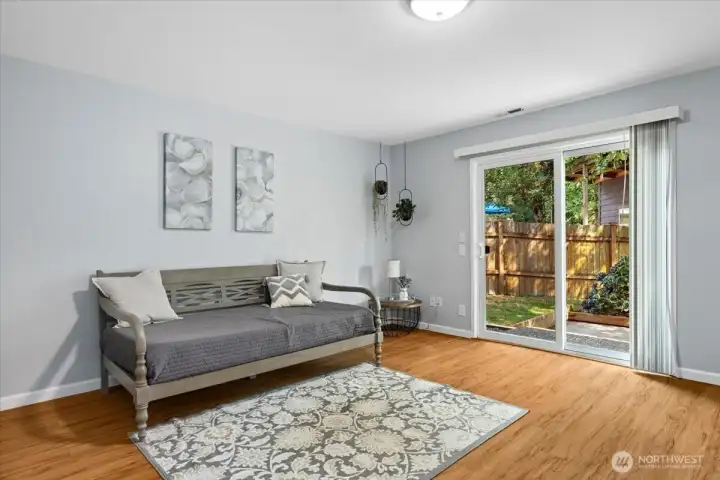 Lower level rec room. Sliding door leads to the back patio.