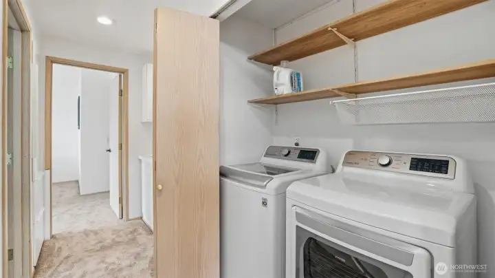 Convenient in-unit laundry with shelving and storage for everyday ease.