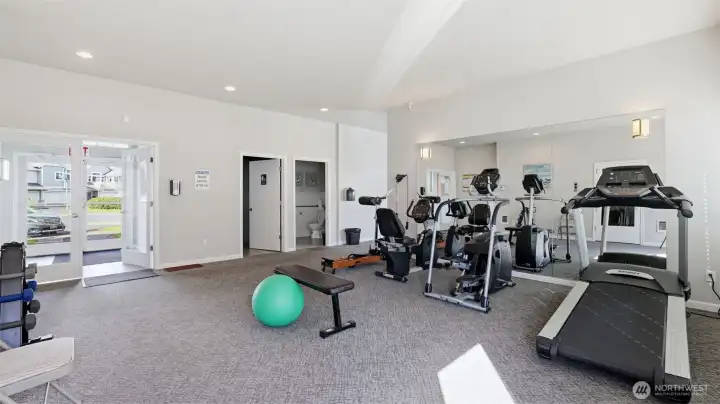 Open layout and bright windows create an inviting fitness environment.