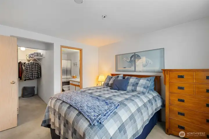 Primary bedroom with walk in closet and primary bathroom