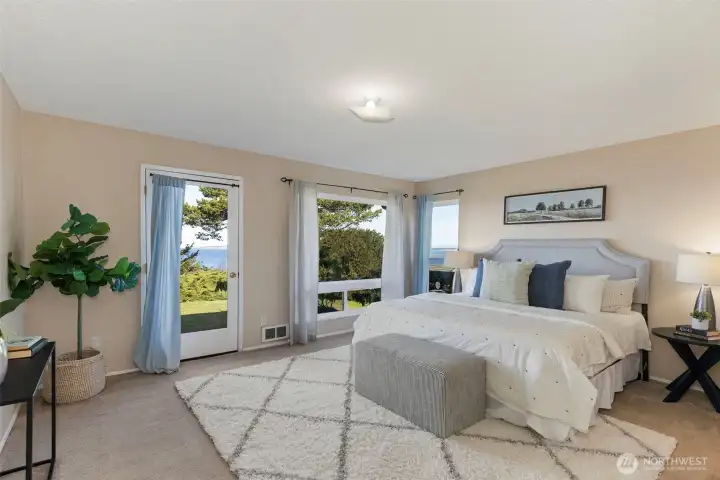 Primary bedroom with access to the back deck and the view.
