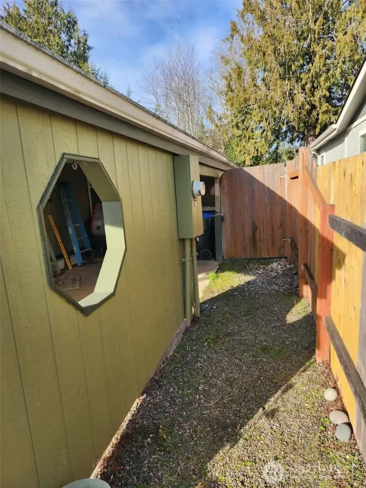 Beside the covered carport is a gravel path leading to a gate that gives you entrance to the fully fenced & private back yard.