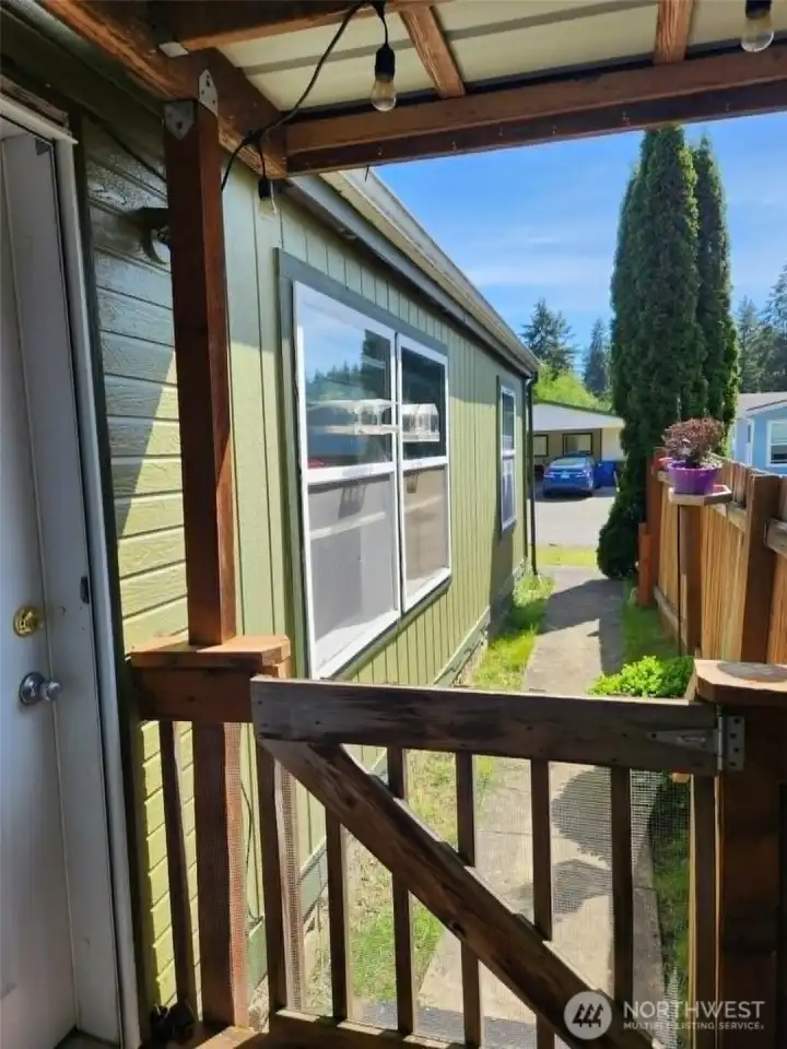 Side walk leading to front door with gate.