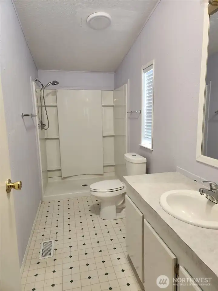 Spacious primary bath with updated walk in shower.