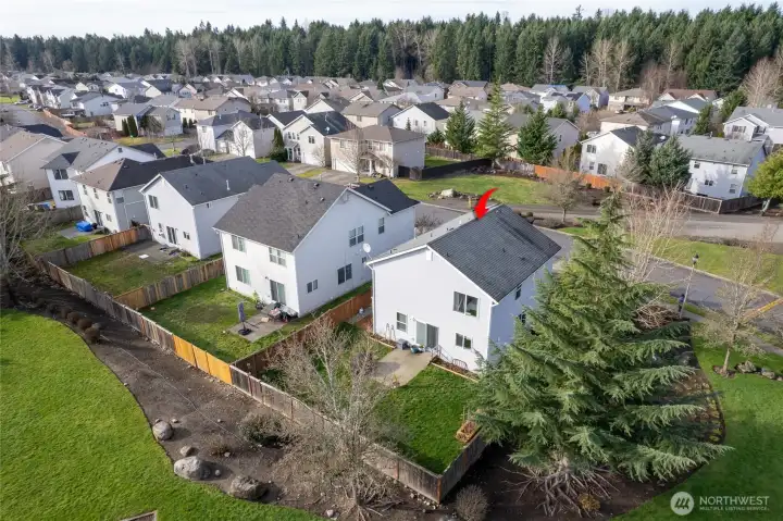 Rear aerial view of home with park