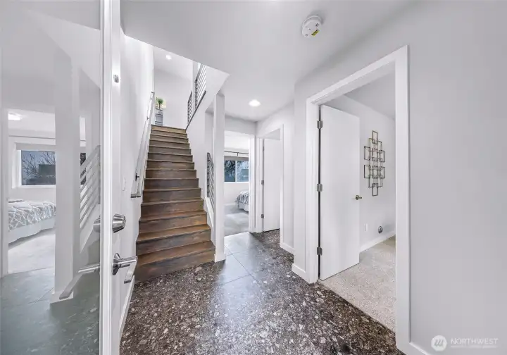 Entry level stairs leading to two downstairs bedrooms and shared bath.