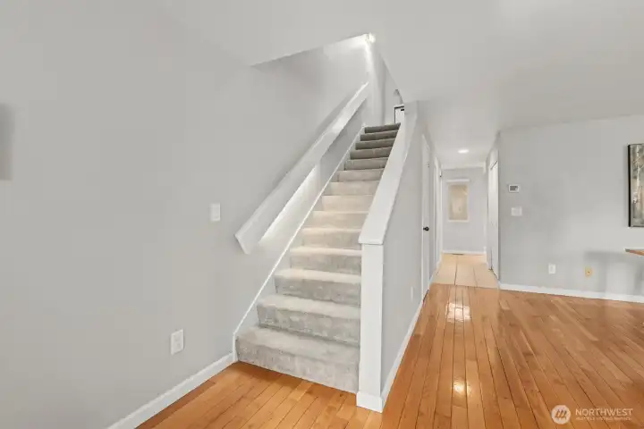 A nice view of the hardwood floors and a shot of the staircase to the upper level.