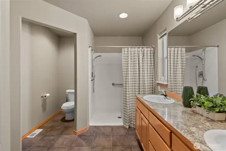 Primary Bath with easy walk-in shower, private water closet.