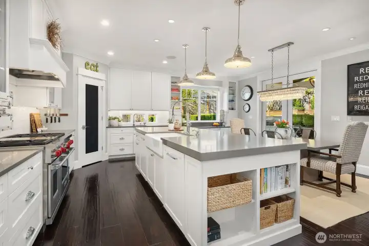 A chef's kitchen with gas range, double oven, beverage bar and spacious island. French doors lead open to the gorgeous covered patio and pristine landscaped back yard!