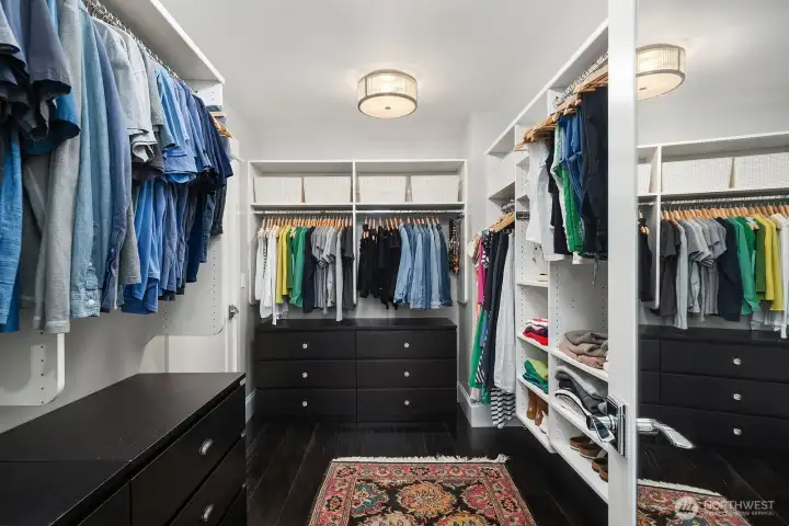 Walk-in closet in primary with access to the upstairs laundry room.