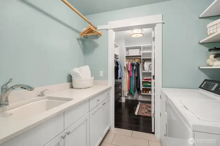 Upstairs laundry room with connection to the hallway and the primary bedroom closet as well.