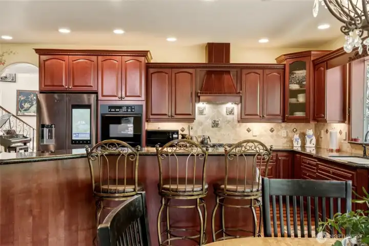 Large kitchen with granite and upgraded appliances.
