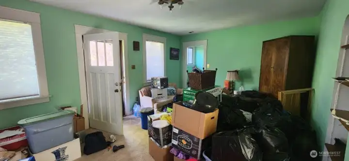Looking from living area back towards front door. The walkway towards the right of the door is the stairway to the upstairs bedrooms.