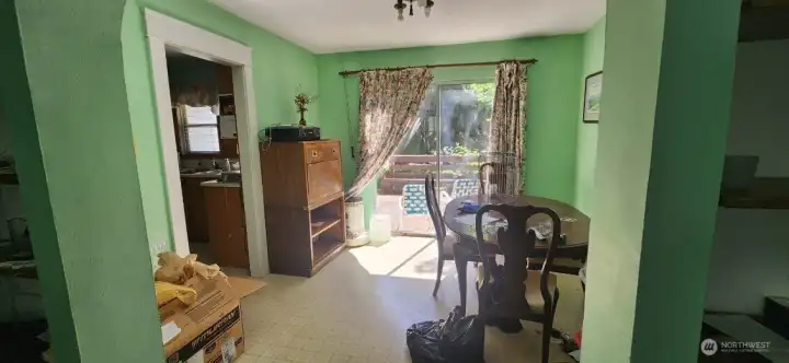 Looking into dining room with kitchen access to the left - notice beautiful original light fixture.