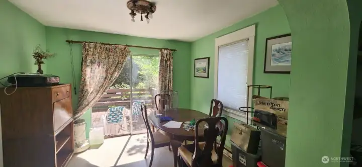 Alternate view of dining room looking out towards large deck with electric hook ups.