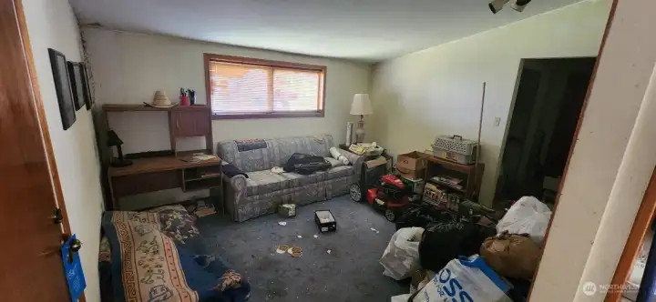 Looking from kitchen into second living space. Door to garage lies directly to the left.