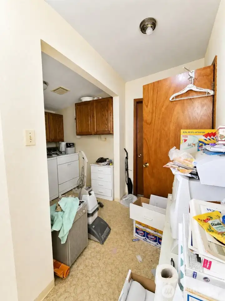 Walking through second living space lets you into a large laundry space with downstairs bathroom with shower directly to the right.