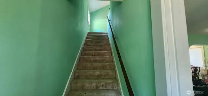 Stairway to upstairs bedrooms and full bath.