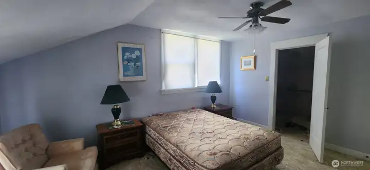 View of your expansive primary bedroom with primary closet directly ahead and ceiling fan.