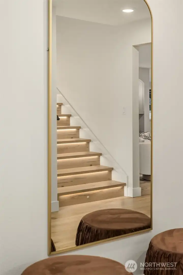 Beautiful staircase has underlighting on each step.