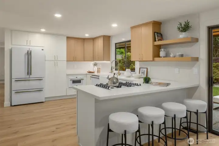 Re-designed kitchen offers quartz countertops, breakfast bar, gas cooktop, and all new Premium Italian appliances