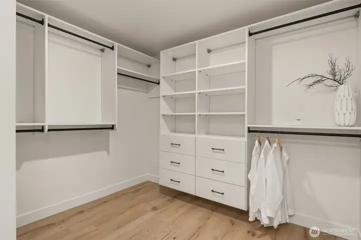 Custom Closet organizers are move-in ready in this oversized walk-in closet.