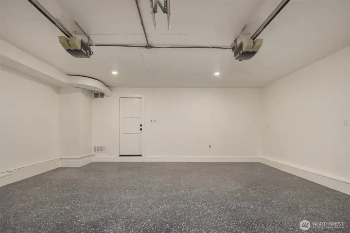 New Epoxy coating on garage floor perfectly enhances this finished garage