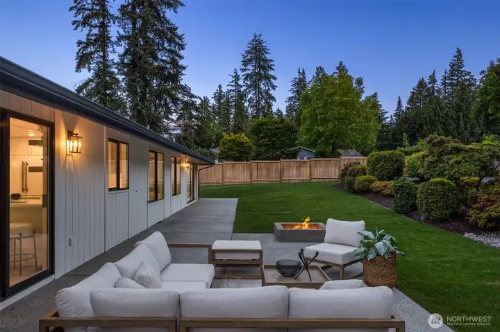 Welcome to your private backyard oasis with newly poured patio, built in fire-pit, newly laid sod and newer fencing.