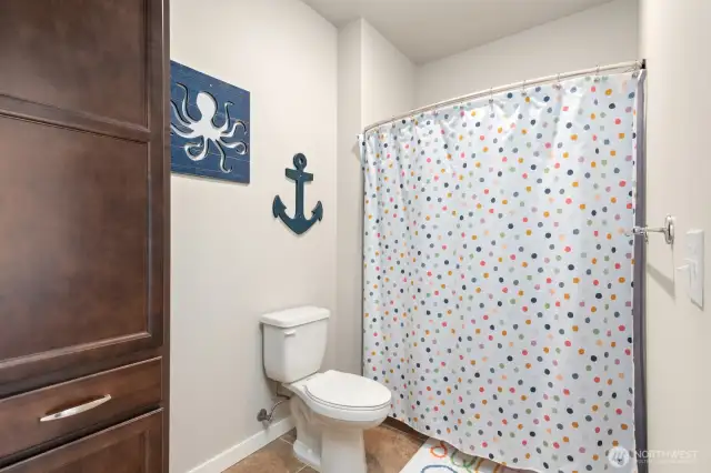 Toilet and shower of upstairs bathroom