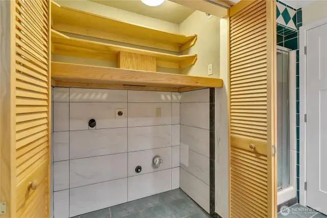 Laundry area in the main floor 3/4 bath.  Custom tile surround.