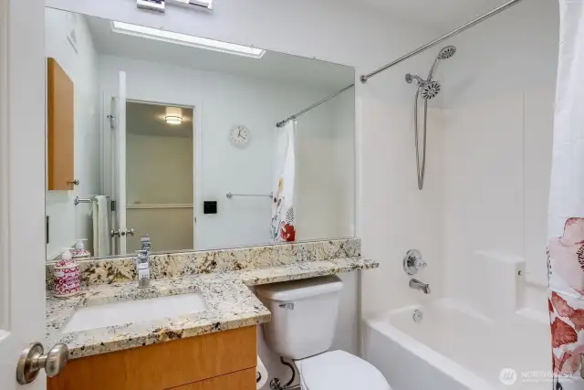 Sparkling clean full bathroom, complete with a versatile tub and shower with removable showerhead.