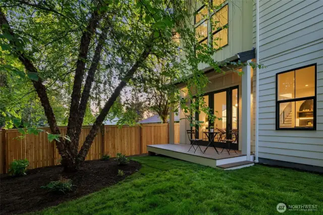 Patio and fully fenced backyard.