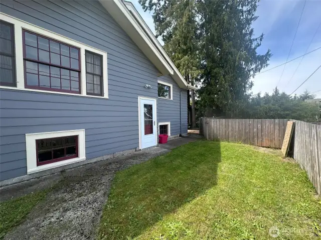 Fenced back area with access to alley parking and garbage can storage.