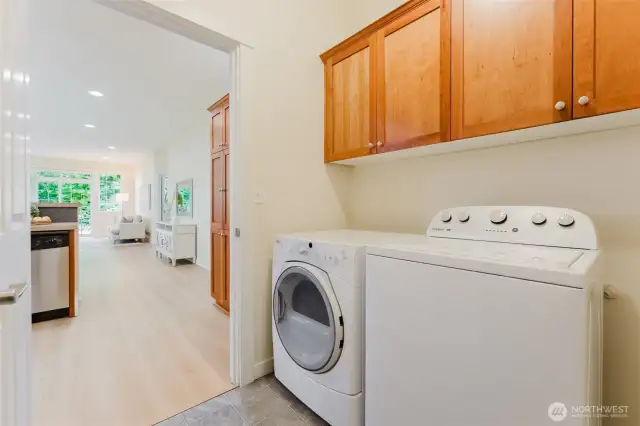 Located between the kitchen and garage, this functional laundry space includes a washer and dryer—both included with the home—as well as plenty of cabinets to store all those laundry essentials, cleaning supplies, and more.
