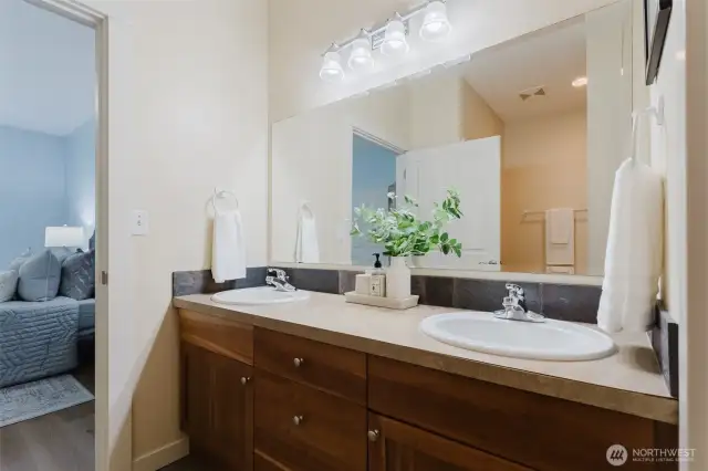 The private ensuite bathroom features a spacious double sink vanity—ideal for busy mornings or winding down in the evening. A clean, functional design that offers comfort and convenience.