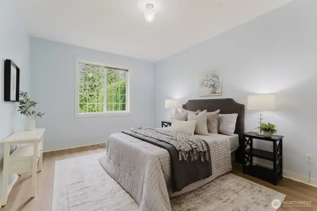 The primary bedroom offers a quiet retreat at the back of the home, with a window overlooking the serene backyard. Soft natural light and a simple layout create a restful space perfect for starting and ending the day in calm comfort.