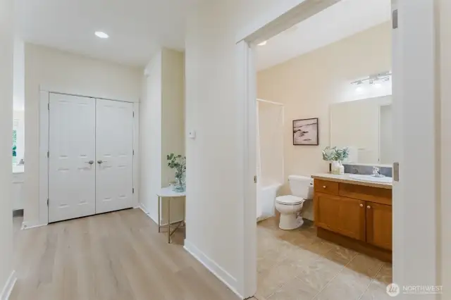 Down the hall, you'll find the first of two full bathrooms, along with a second generous closet—ideal for stashing everything from winter coats to beach towels. Practical storage that keeps life beautifully organized.