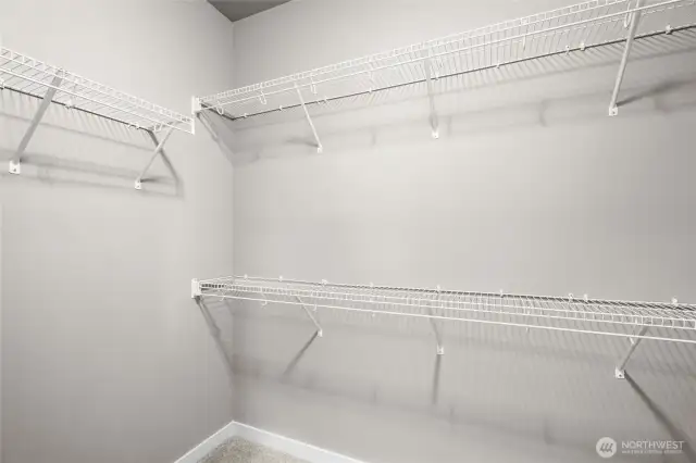 Expansive walk-in closet with custom shelving and plenty of room for wardrobe organization.