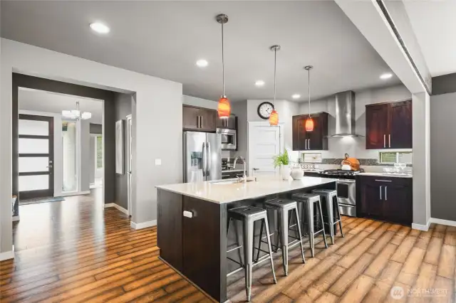 Gorgeous modern kitchen featuring sleek countertops, stainless steel appliances, a massive center island, and ample cabinet space—perfect for entertaining or everyday cooking.