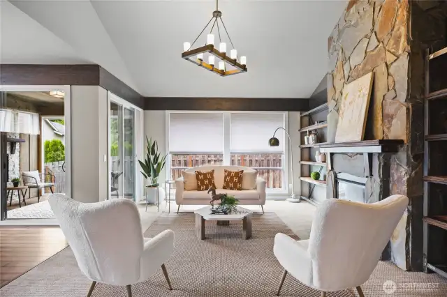 Bright and airy living room with large windows, stylish flooring, built in shelving, and a seamless flow to the main living areas.
