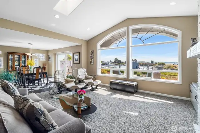 Large living room has room for plenty of seating and has bookcases for lots of display area for art, books and more!