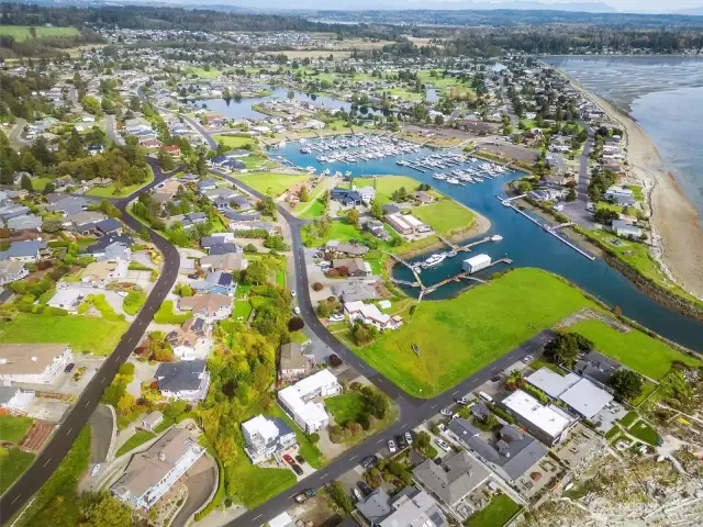 in the foreground is house with dock, then the shot pans back to the marina and Village amentiies.